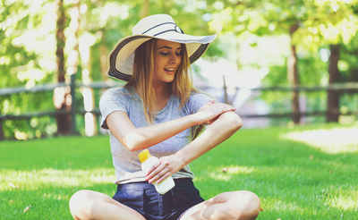 woman applying sunscreen