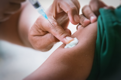 doctor injecting patient with vaccine