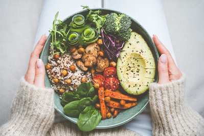 person holding plate of healthy food