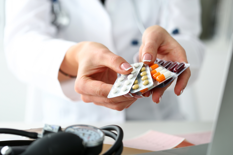 pharmacist holding pill packs