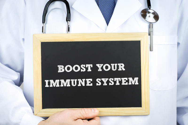 doctor holding sign that says boost your immune system